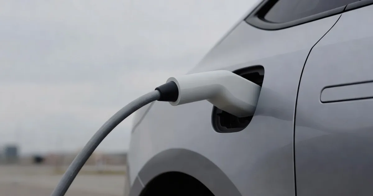 A charging cable arcing from an unbranded blank fast charger to the side of an electric car